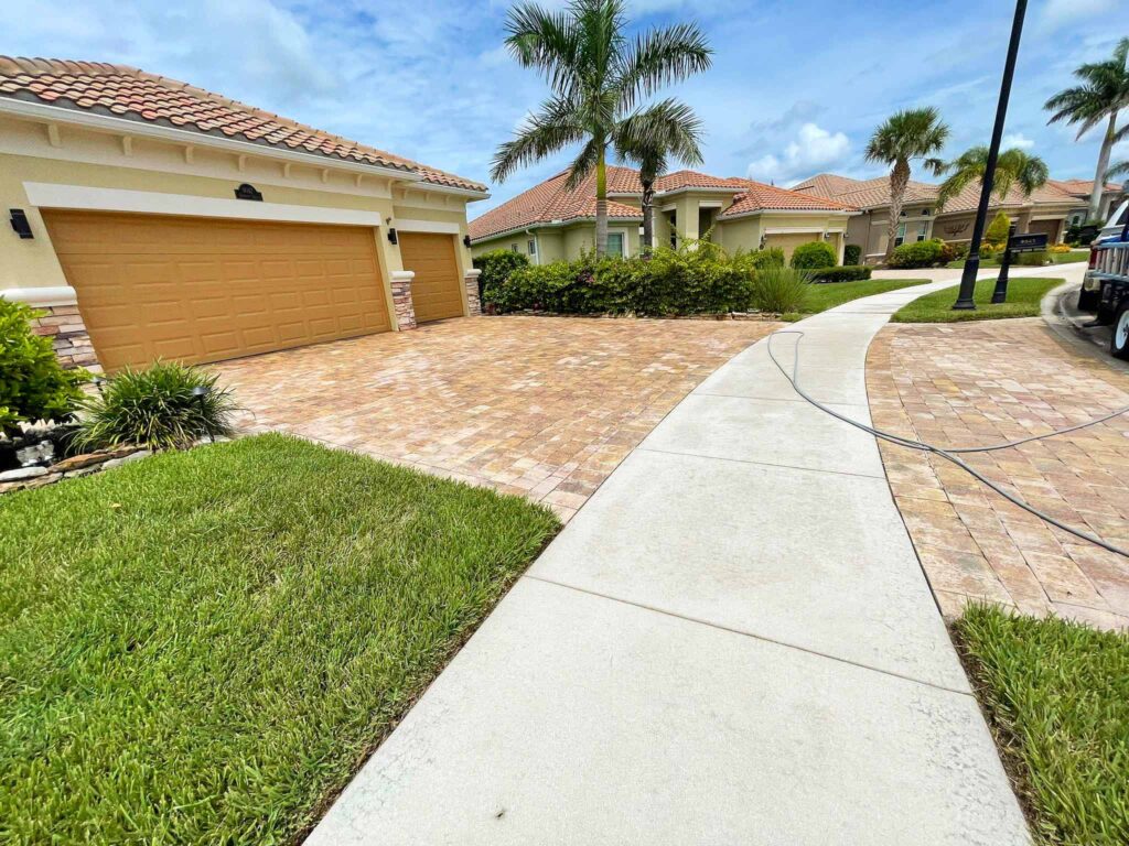 Pressure washing driveway in Naples Florida by Happy Home Detailing 34108