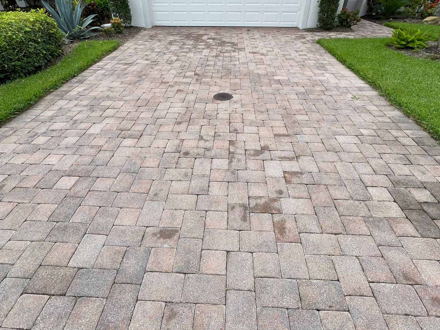 dirty driveway with pavers before pressure washing