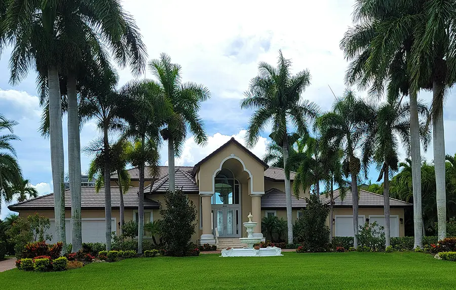 Luxury home in Florida, surrounded by palm trees.