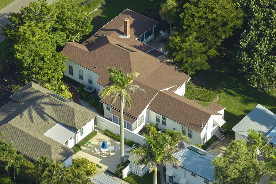 Aerial view from above of large residential houses surrounded by trees in Florida.